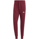 Spodnie męskie adidas Essentials French Terry Tapered Cuff 3-Stripes bordowe IS1366